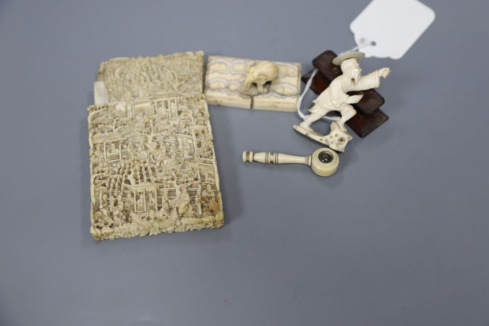 A 19th century ivory card case, an ivory miniature spy glass, an ivory elephant and another figure
